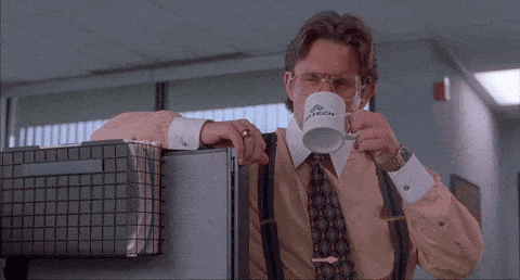 Office space boss drinking coffee next to cubicle with a judging face